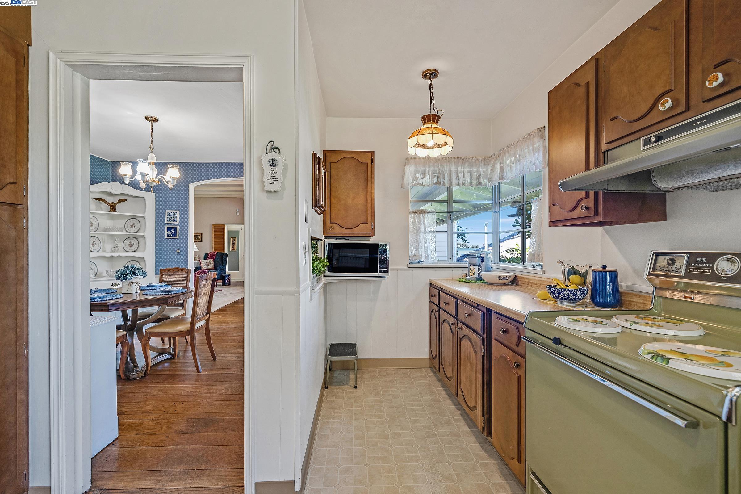 2863 Burton Drive Oakland, CA 94611 - Photo 13 of 34 a kitchen with stainless steel appliances granite countertop a sink a stove and a refrigerator