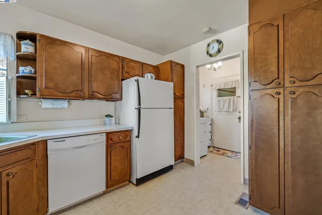 a kitchen with a refrigerator a sink and cabinets