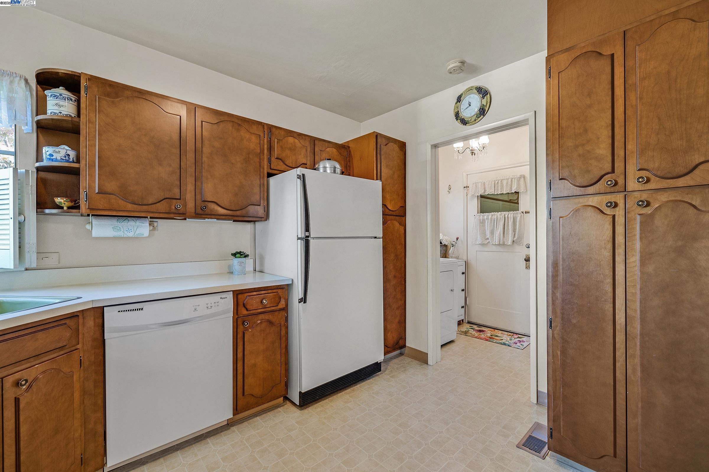 2863 Burton Drive Oakland, CA 94611 - Photo 14 of 34 a kitchen with a refrigerator a sink and cabinets