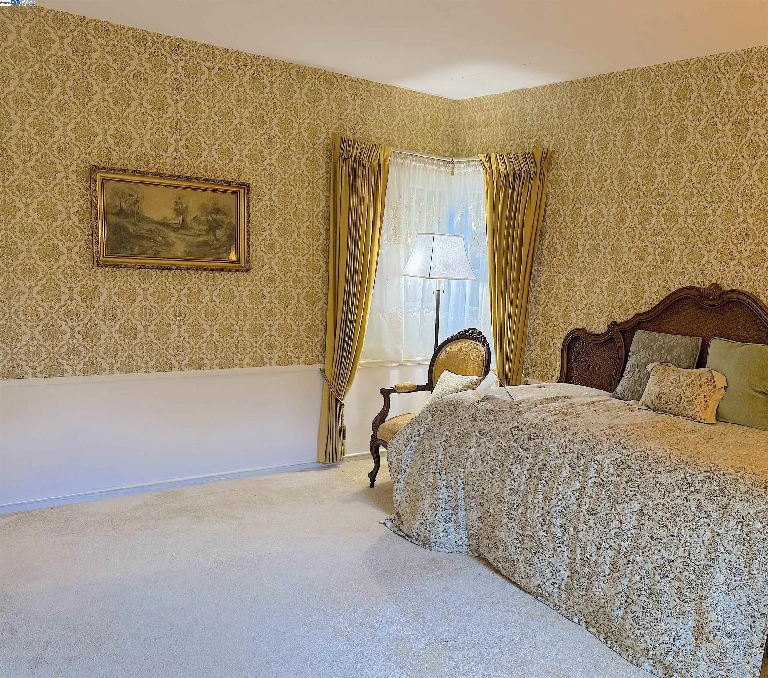 2863 Burton Drive Oakland, CA 94611 - Photo 16 of 34 a bedroom with a bed and a painting on the wall