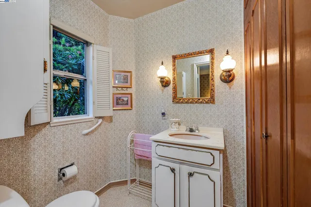 a bathroom with a sink a mirror and a window