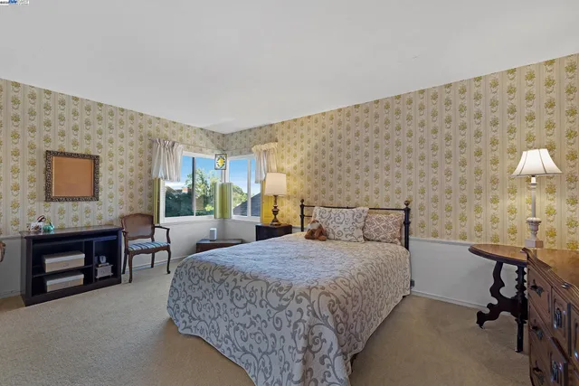 a bedroom with a bed and a table in it