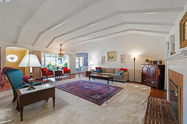 a living room with furniture a rug and a fireplace