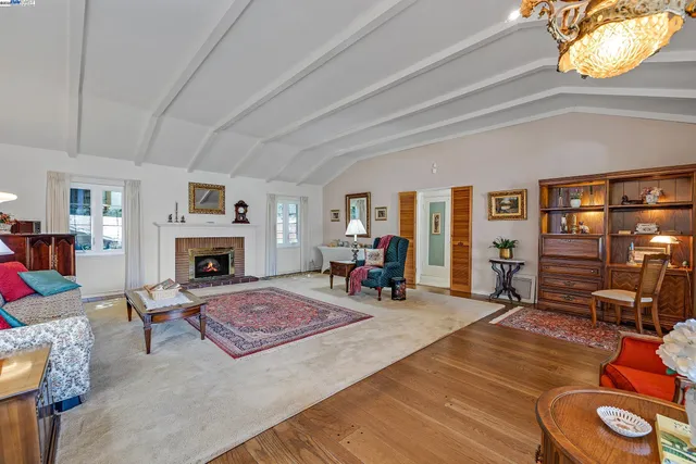 a living room with furniture a fireplace and a large window