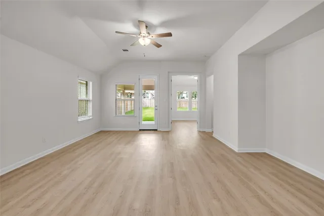 a kitchen with granite countertop white cabinets and stainless steel appliances