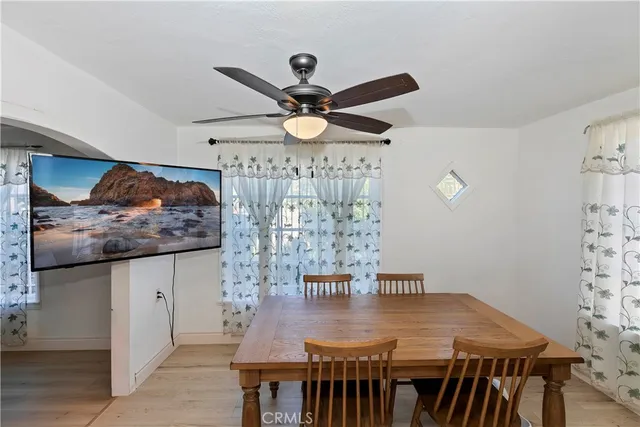 a view of a dining room with furniture and a chandelier