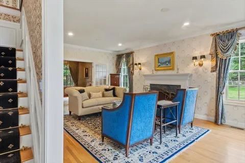 a living room with furniture a fireplace and a large window