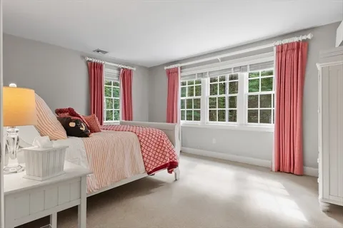 a bed sitting in a bedroom next to a window