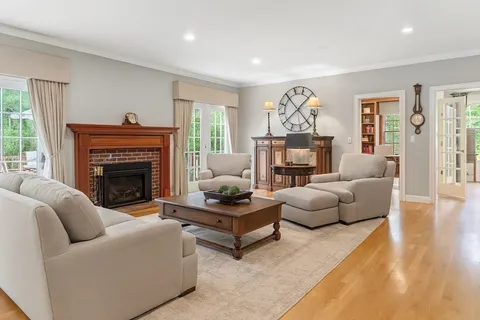 a living room with furniture a fireplace and a large window