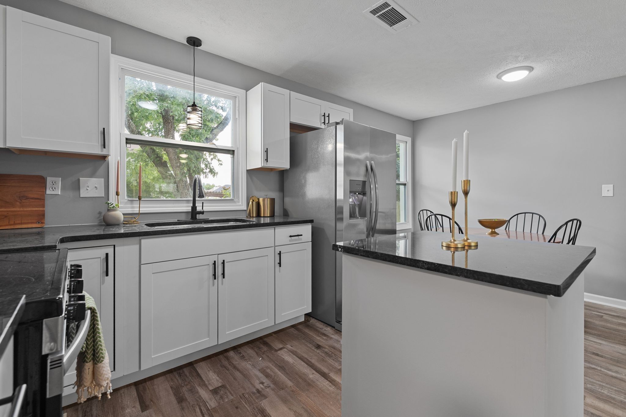 544 Stones River Road La Vergne, TN 37086 - Photo 13 of 27 a kitchen with stainless steel appliances granite countertop a sink a stove and a refrigerator