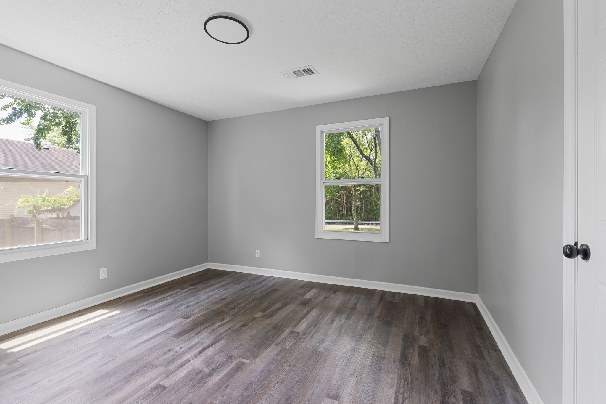 544 Stones River Road La Vergne, TN 37086 - Photo 18 of 27 an empty room with wooden floor and windows