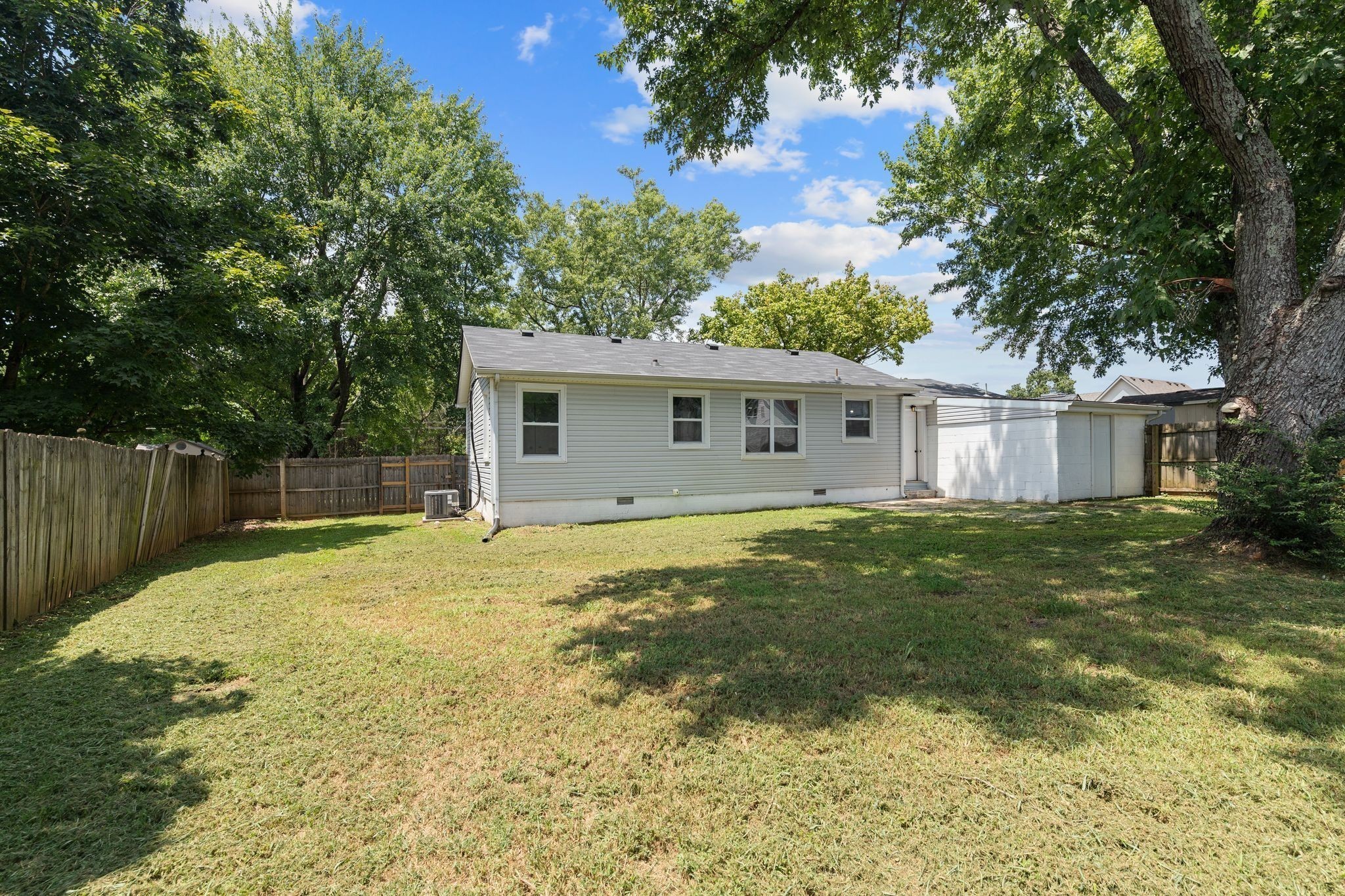 544 Stones River Road La Vergne, TN 37086 - Photo 27 of 27 a backyard of a house with large trees and wooden fence