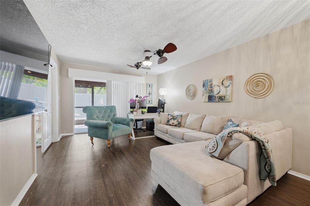 2074 Sunset Point Road, Unit 137 Clearwater, FL 33765 - Photo 16 of 32 a living room with furniture and wooden floor
