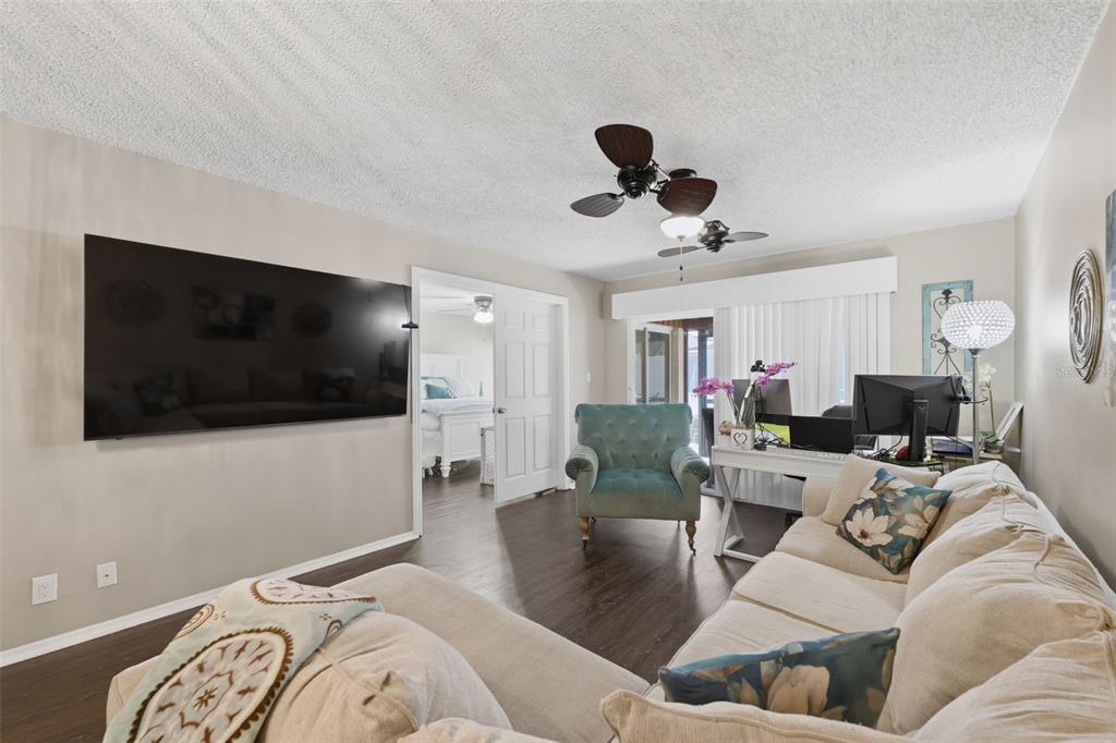 2074 Sunset Point Road, Unit 137 Clearwater, FL 33765 - Photo 17 of 32 a living room with furniture and a flat screen tv