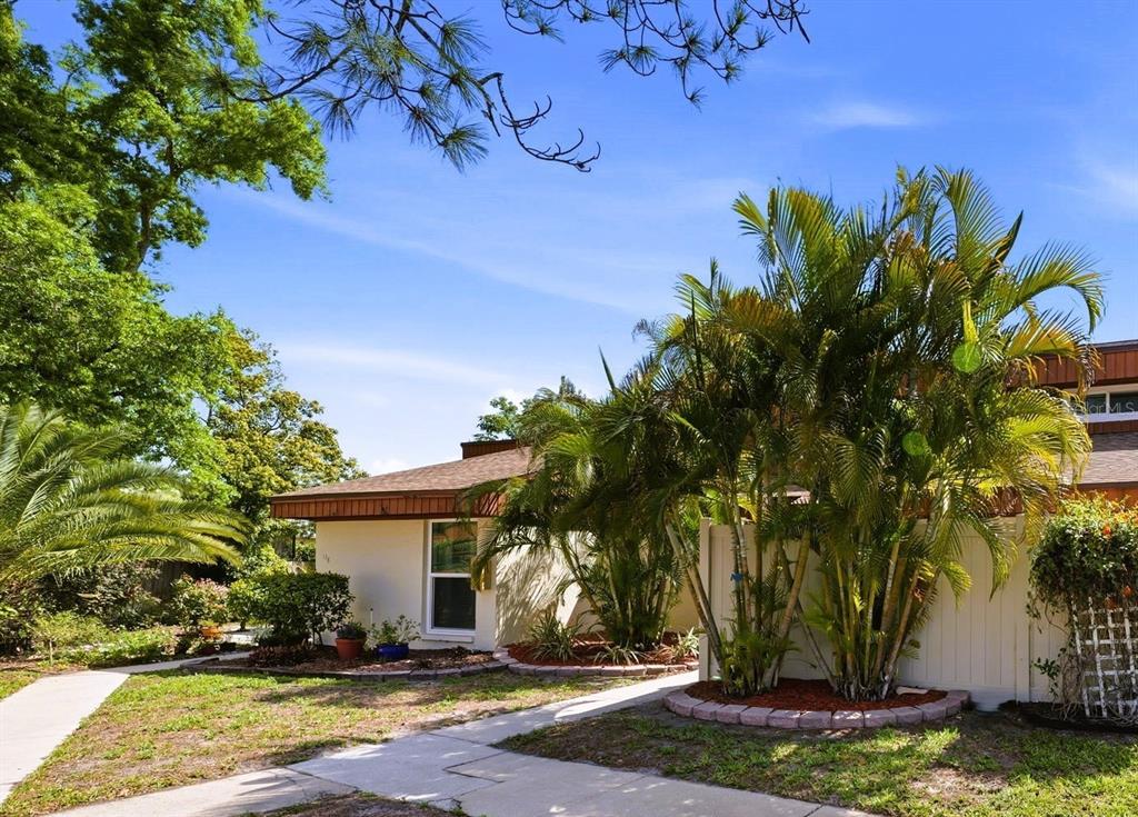 2074 Sunset Point Road, Unit 137 Clearwater, FL 33765 - Photo 2 of 32 a front view of a house with a yard