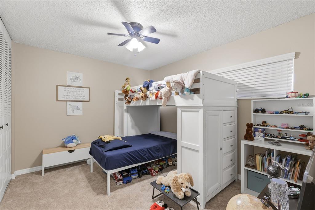 2074 Sunset Point Road, Unit 137 Clearwater, FL 33765 - Photo 21 of 32 a living room with furniture and a book shelf