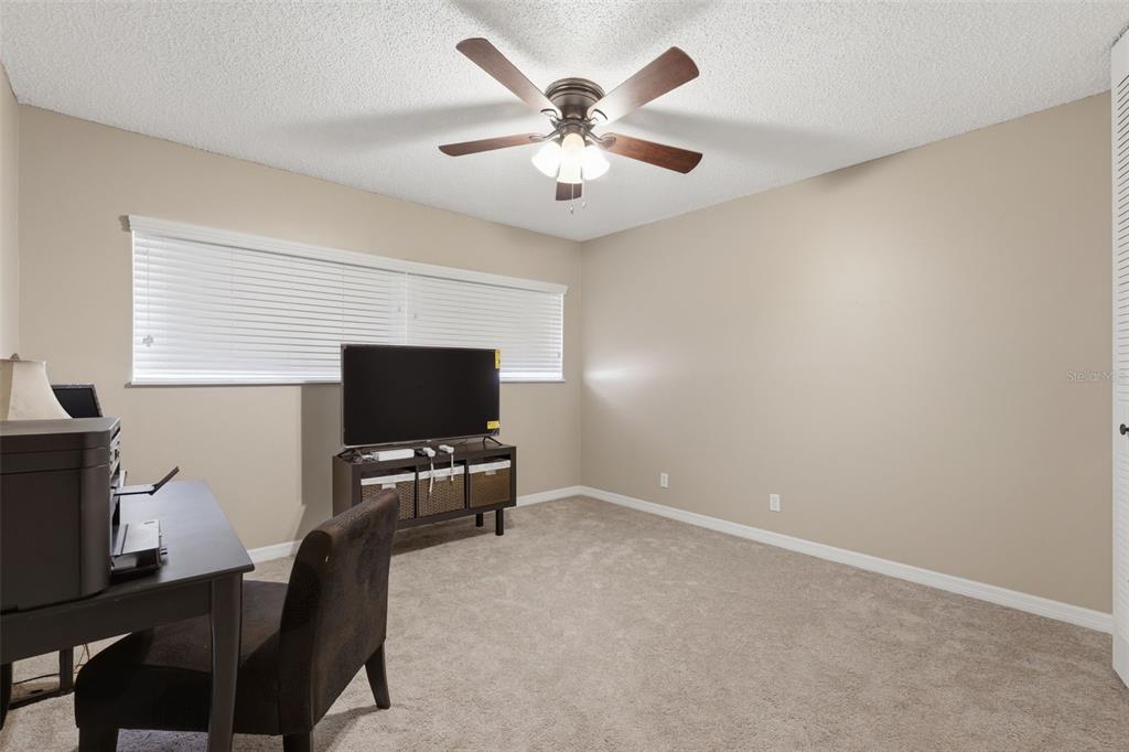 2074 Sunset Point Road, Unit 137 Clearwater, FL 33765 - Photo 24 of 32 a living room with furniture and a flat screen tv