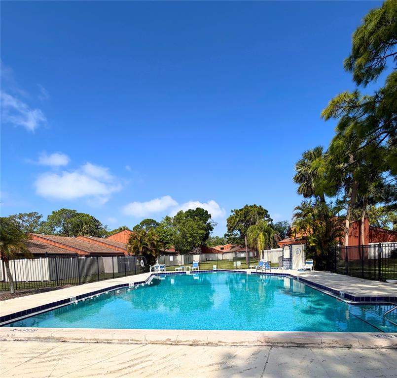 2074 Sunset Point Road, Unit 137 Clearwater, FL 33765 - Photo 27 of 32 a view of swimming pool with outdoor seating and deck