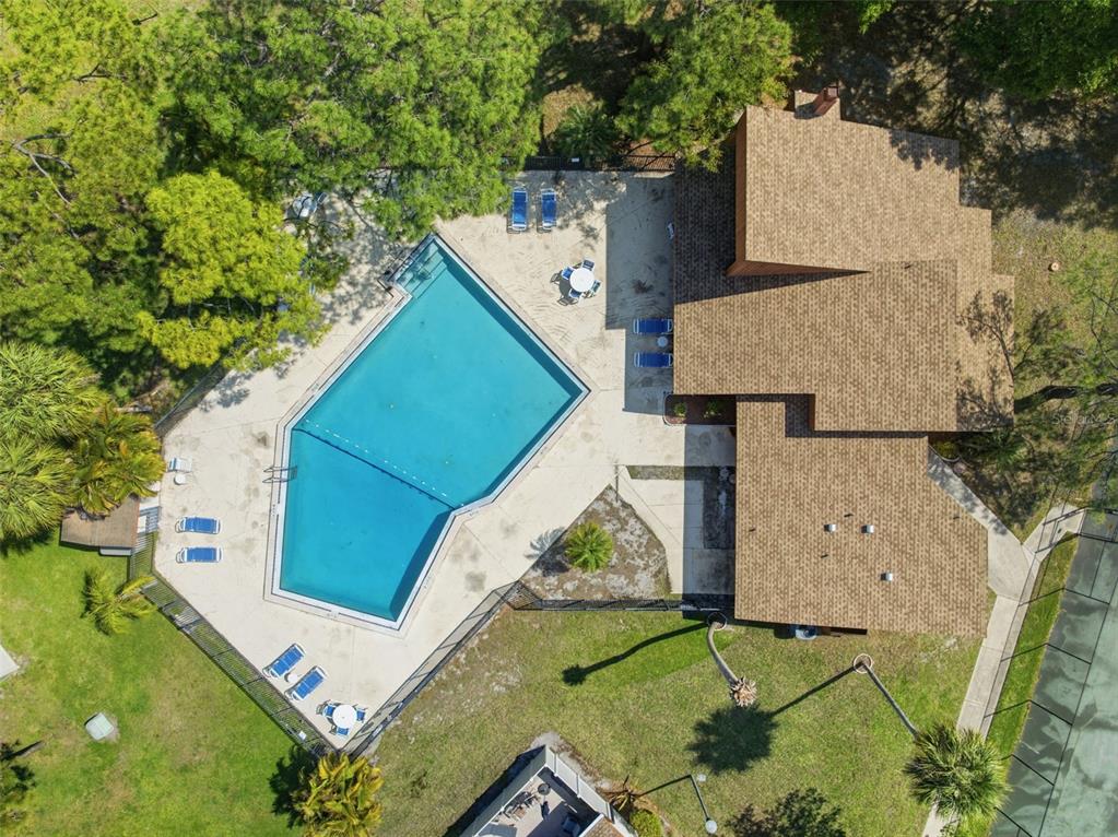 2074 Sunset Point Road, Unit 137 Clearwater, FL 33765 - Photo 28 of 32 an aerial view of a house with a yard and trees