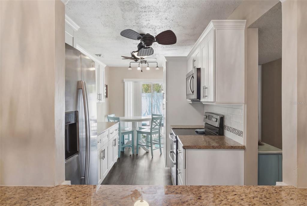 2074 Sunset Point Road, Unit 137 Clearwater, FL 33765 - Photo 8 of 32 a living room with stainless steel appliances granite countertop furniture and a fireplace
