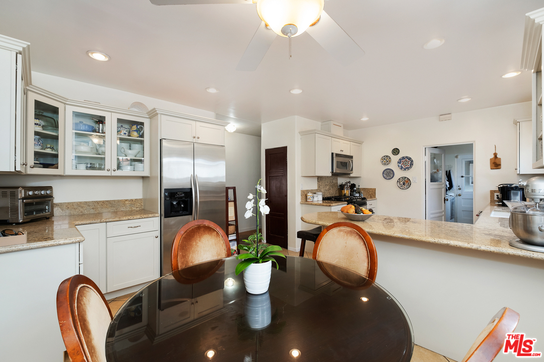 806 Palm Drive Glendale, CA 91202 - Photo 10 of 29 a kitchen with stainless steel appliances granite countertop a stove top oven a sink dishwasher and cabinets with wooden floor