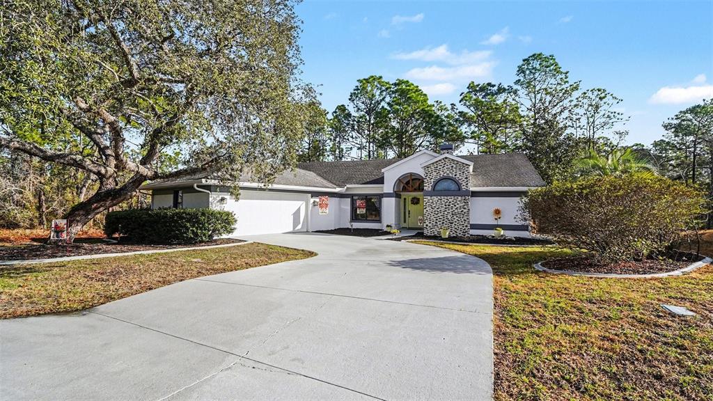 17 Longleaf Court Homosassa, FL 34446 - Photo 1 of 30 a front view of a house with yard and trees