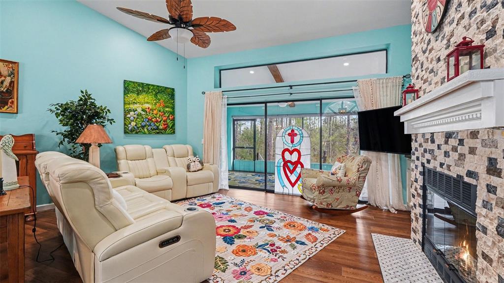 17 Longleaf Court Homosassa, FL 34446 - Photo 4 of 30 a living room with furniture a flat screen tv and a fireplace