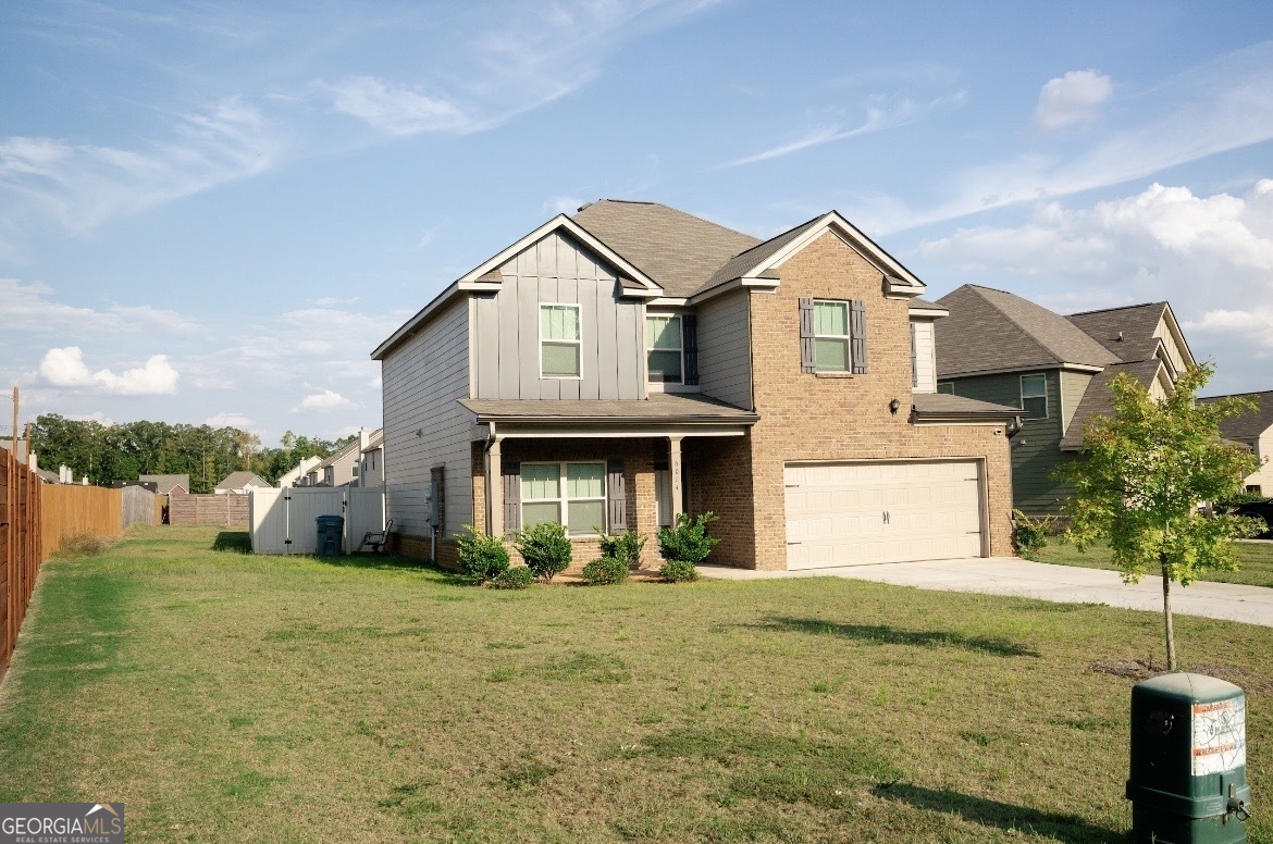 6014 Prodigy Lane Locust Grove, GA 30248 - Photo 1 of 7 a front view of a house with a yard