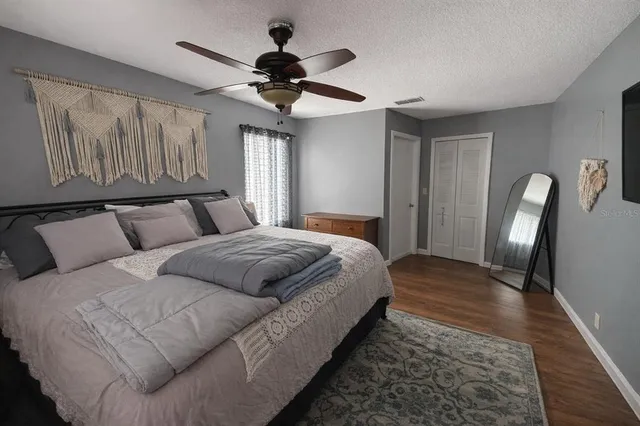 a bedroom with a large bed and a chandelier