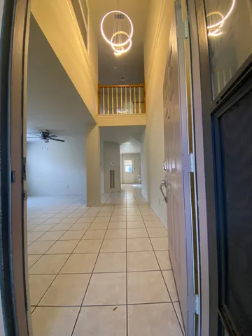 an empty room with windows and ceiling fan