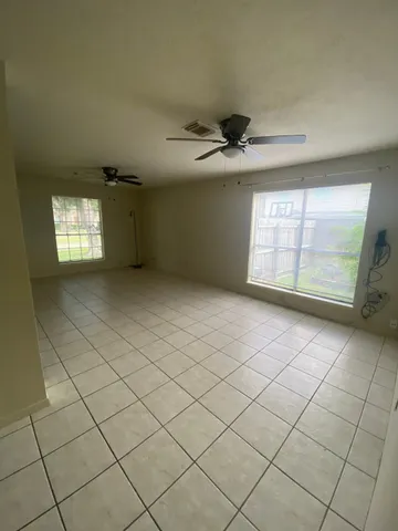 an empty room with wooden floor and a window