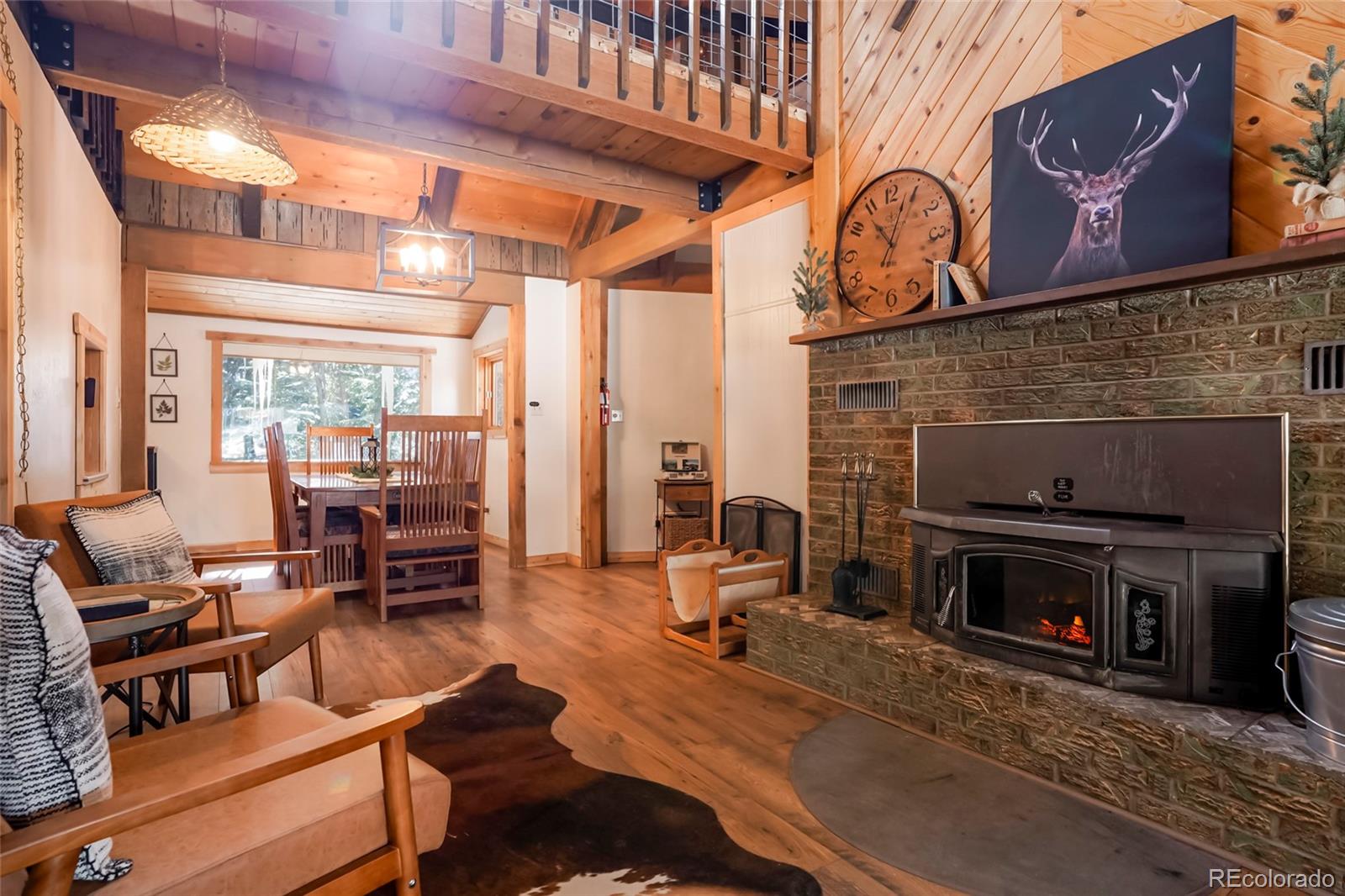 3237 Mill Creek Road Dumont, CO 80436 - Photo 11 of 48 a living room with furniture a flat screen tv and a fireplace