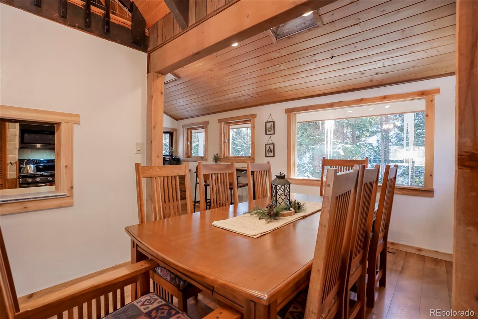 3237 Mill Creek Road Dumont, CO 80436 - Photo 13 of 48 a view of a dining room with furniture window and wooden floor