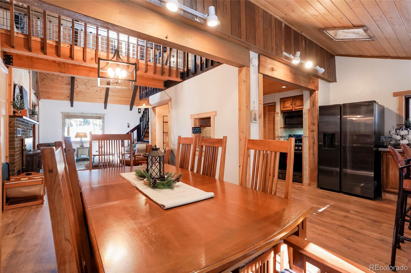 3237 Mill Creek Road Dumont, CO 80436 - Photo 14 of 48 a view of a dining room with furniture a chandelier and wooden floor