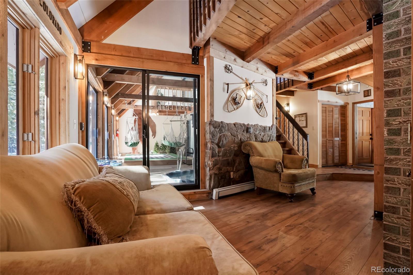 3237 Mill Creek Road Dumont, CO 80436 - Photo 17 of 48 a living room with furniture and a floor to ceiling window