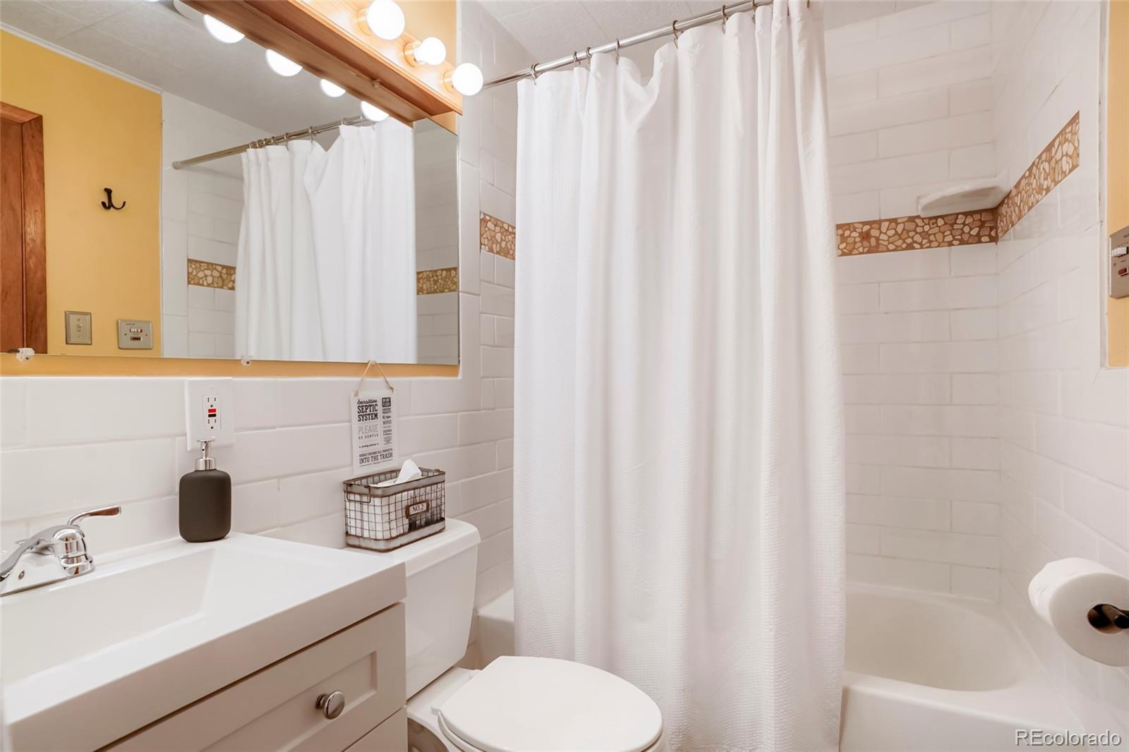 3237 Mill Creek Road Dumont, CO 80436 - Photo 21 of 48 a bathroom with a sink a toilet and a tub