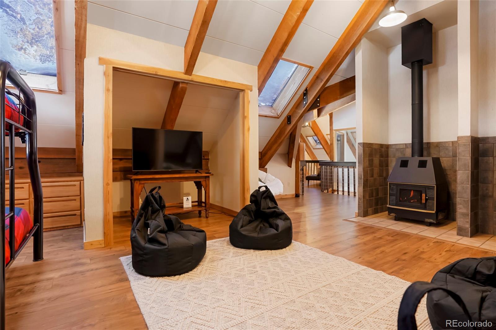 3237 Mill Creek Road Dumont, CO 80436 - Photo 33 of 48 a room with furniture a flat screen tv and a fireplace