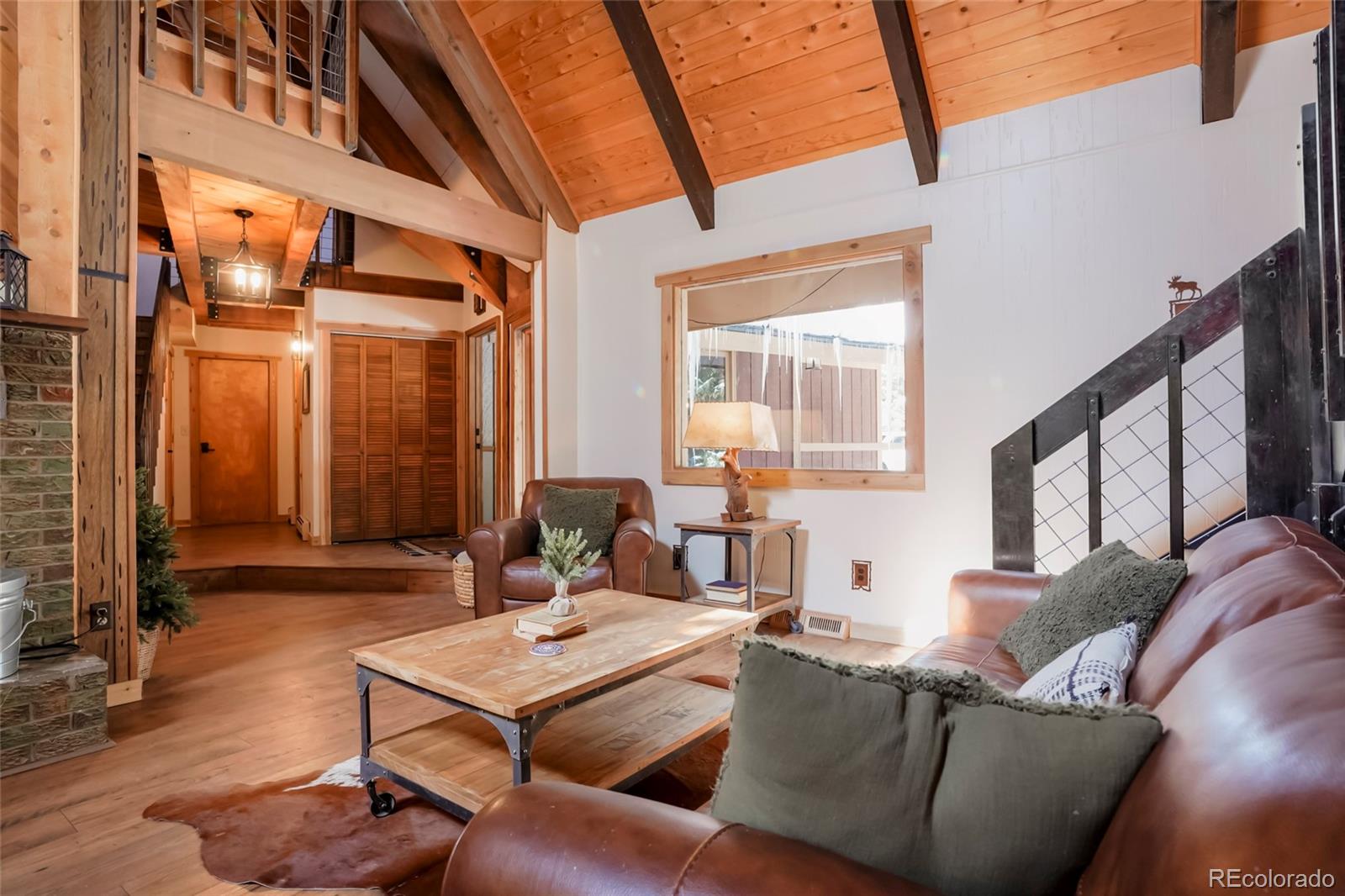 3237 Mill Creek Road Dumont, CO 80436 - Photo 10 of 48 a living room with furniture a large window and a wooden floor