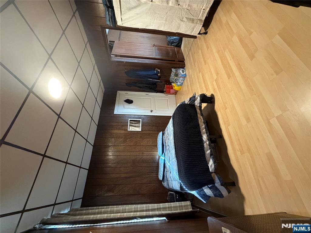 373 McKinley Street Fairview, NJ 07022 - Photo 4 of 8 a bedroom with a bed and a mirror