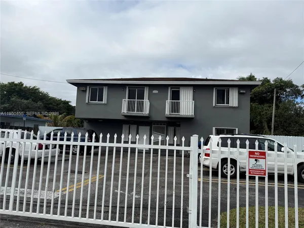 a view of a house with a deck and furniture