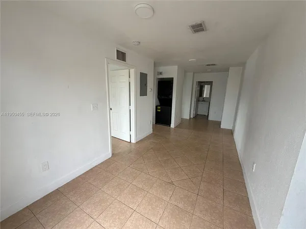 a view of an empty room and fire place
