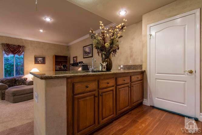 11226 Bentcreek Road Moorpark, CA 93021 - Photo 14 of 41 a kitchen with stainless steel appliances granite countertop a refrigerator and a sink