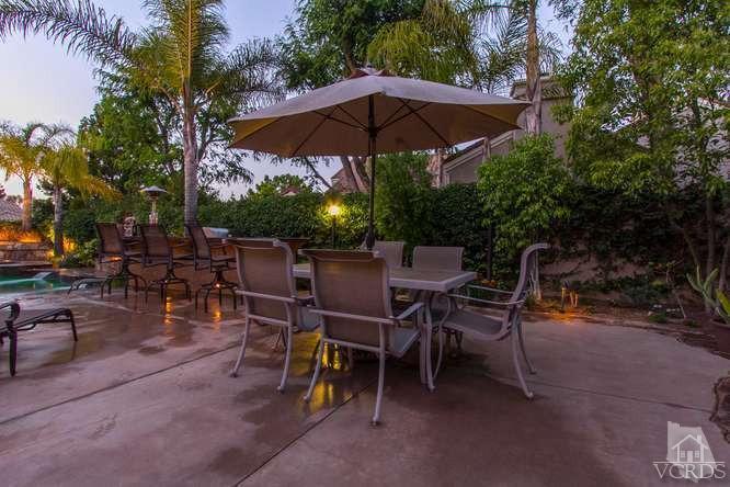 11226 Bentcreek Road Moorpark, CA 93021 - Photo 40 of 41 a view of a chairs and table under an umbrella in backyard