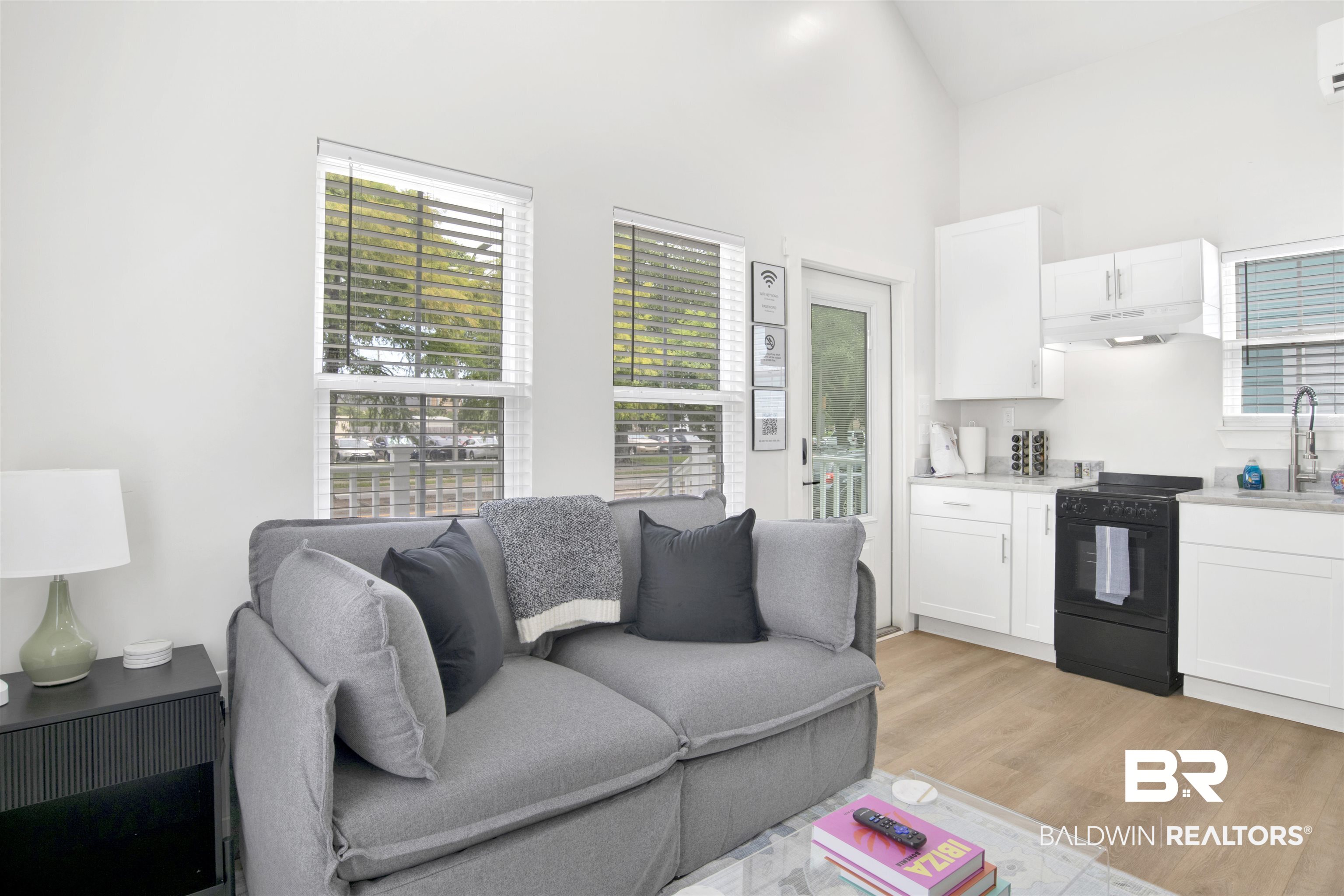 555 Congress Street Mobile, AL 36603 - Photo 12 of 27 Living area with light wood-style flooring and vaulted ceiling