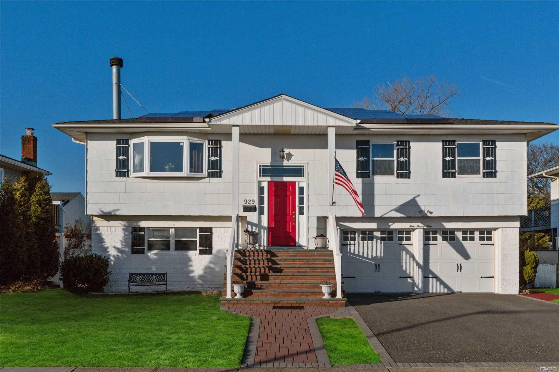 929 Marginal Road Lido Beach, NY 11561 - Photo 1 of 1 a front view of a house with a garden
