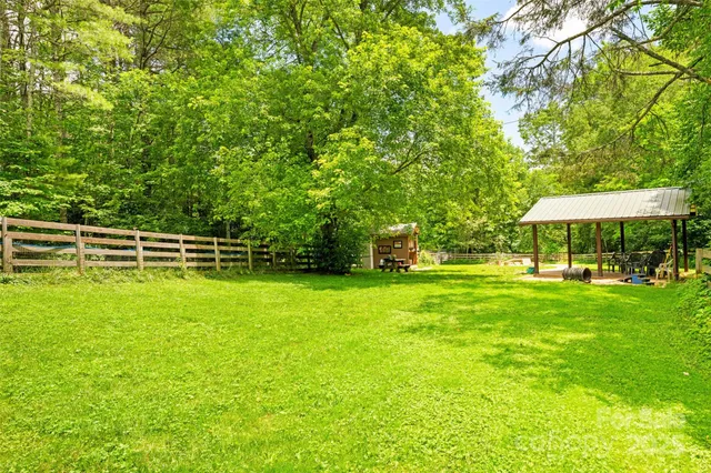 a patio with a table and chairs and a barbeque