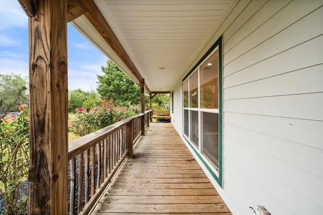 a view of balcony with wooden floor