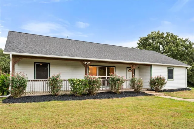 a front view of house with yard and green space