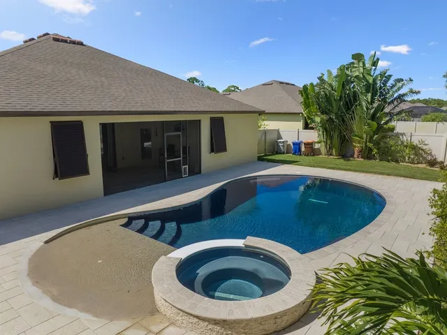 a view of a house with swimming pool and porch