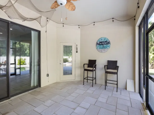a view of a hallway with seating area and entryway